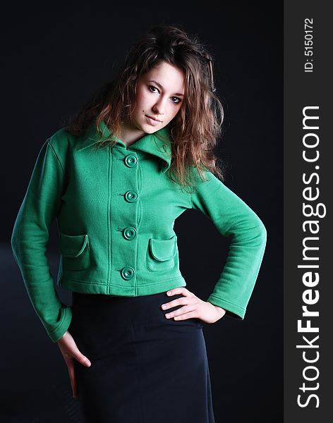 Beauty fashion woman in green clothes at black background. Beauty fashion woman in green clothes at black background