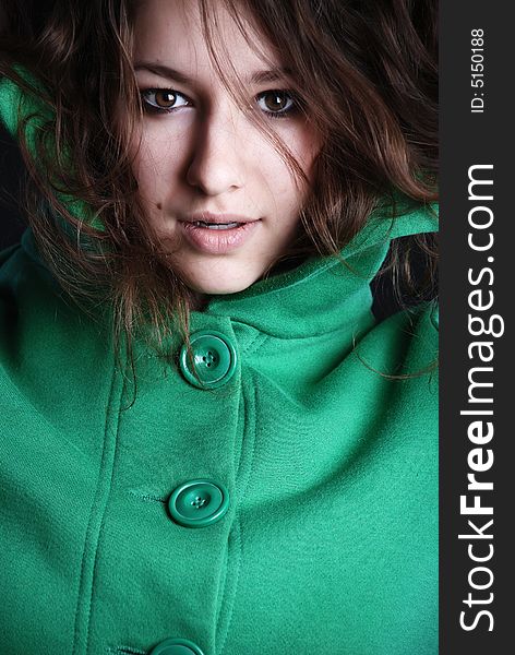 Beauty fashion woman in green clothes at black background. Beauty fashion woman in green clothes at black background