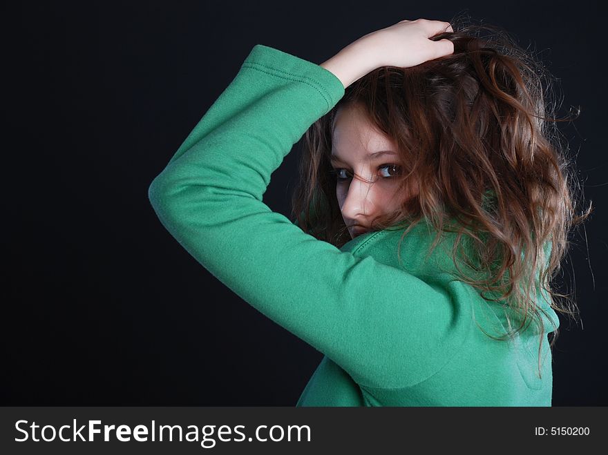 Beauty fashion woman in green clothes at black background. Beauty fashion woman in green clothes at black background
