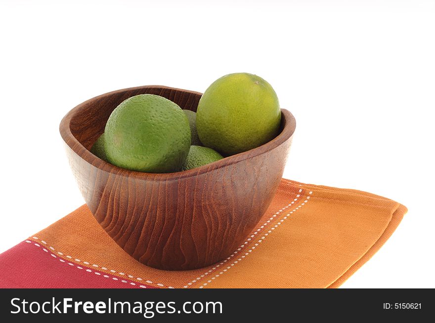 Wooden bowl filled with fresh green limes,. Wooden bowl filled with fresh green limes,