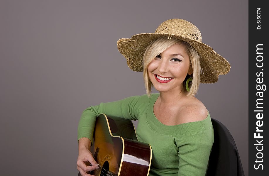 Blonde Playing Guitar With Big Smile