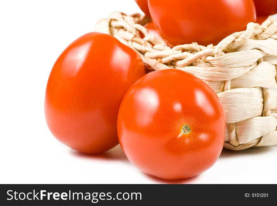 Fresh tomatoes in basket isolated on a white background. Clipping path included. Fresh tomatoes in basket isolated on a white background. Clipping path included.