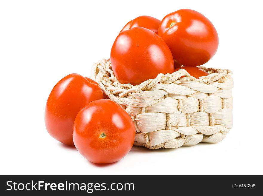 Fresh tomatoes in basket isolated on a white background. Clipping path included. Fresh tomatoes in basket isolated on a white background. Clipping path included.