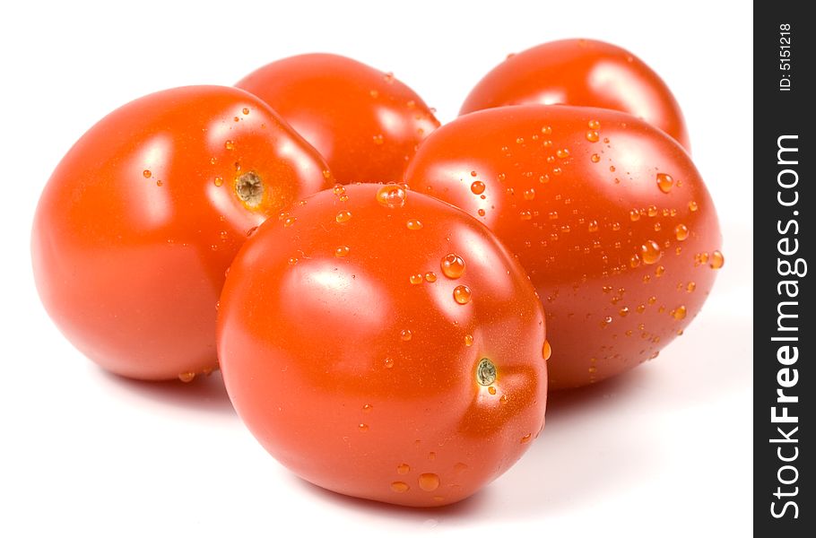 Fresh tomatoes with waterdrops isolated on a white background. Fresh tomatoes with waterdrops isolated on a white background.