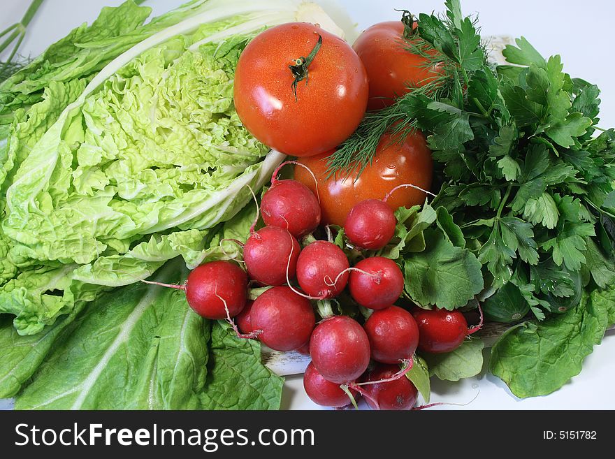 Garden radish, leaves of salad, tomatoes, cucumbers and parsley. Garden radish, leaves of salad, tomatoes, cucumbers and parsley.