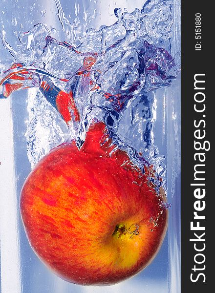 Splashing apple into a water