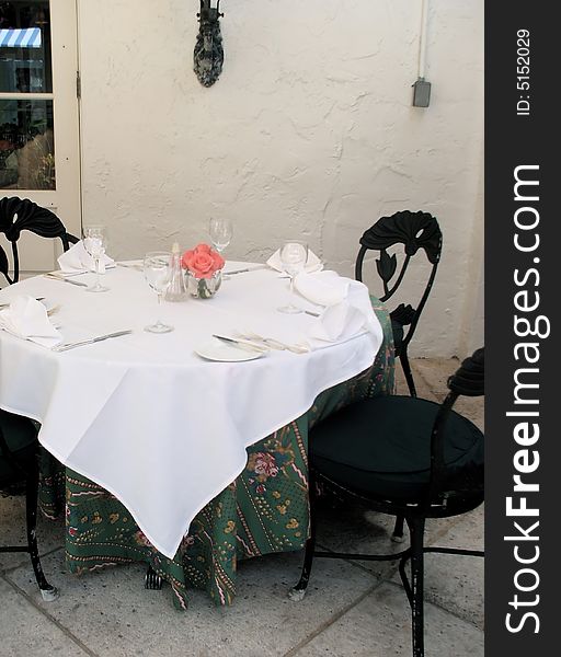 Traditional Table Place Setting with Fresh Pink Roses in Restaurant