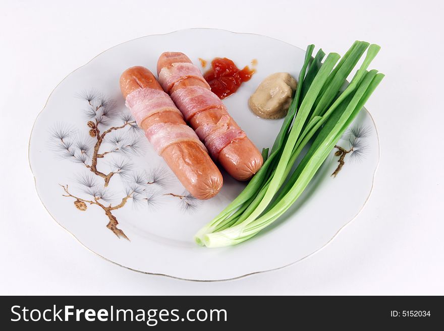 Sausages with a bacon, spring onions, mustard and sharp sauce