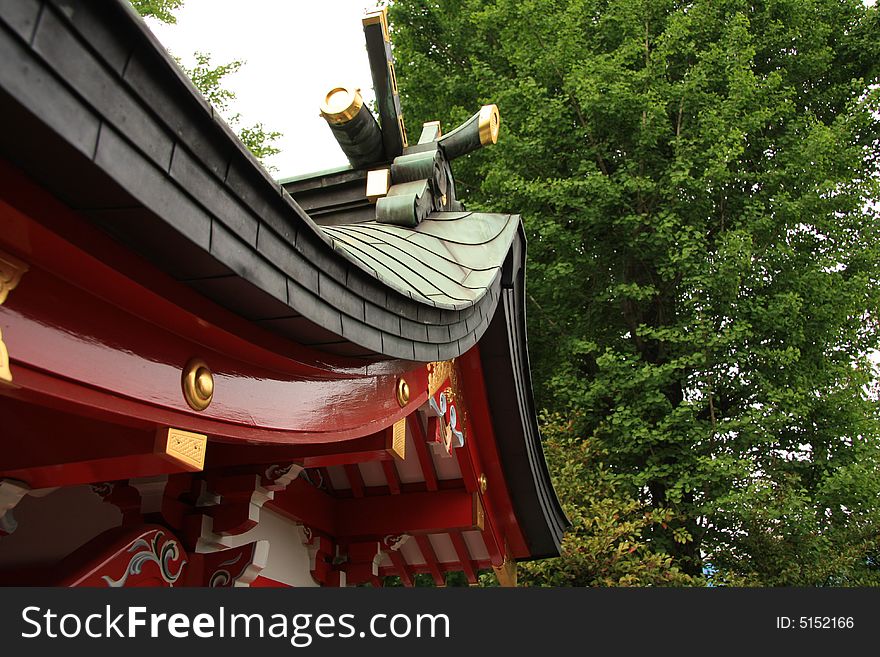 A photograph of a beautifully decorated roof of a japanese temple in Tokyo. A photograph of a beautifully decorated roof of a japanese temple in Tokyo.