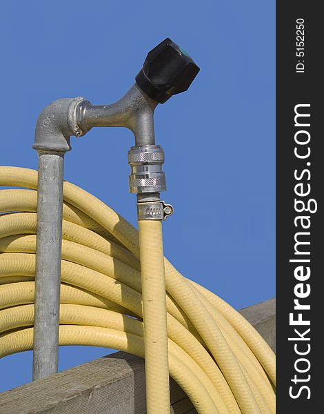 Faucet with a yellow hose for gardening
