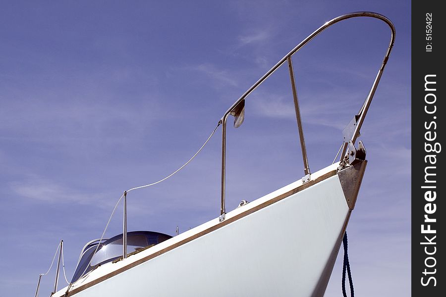 White boat from the front with a blue sky background