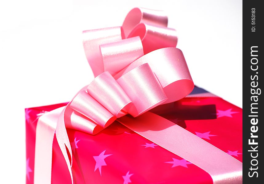 Shot of a gift wrapped in pink paper and pink ribbon