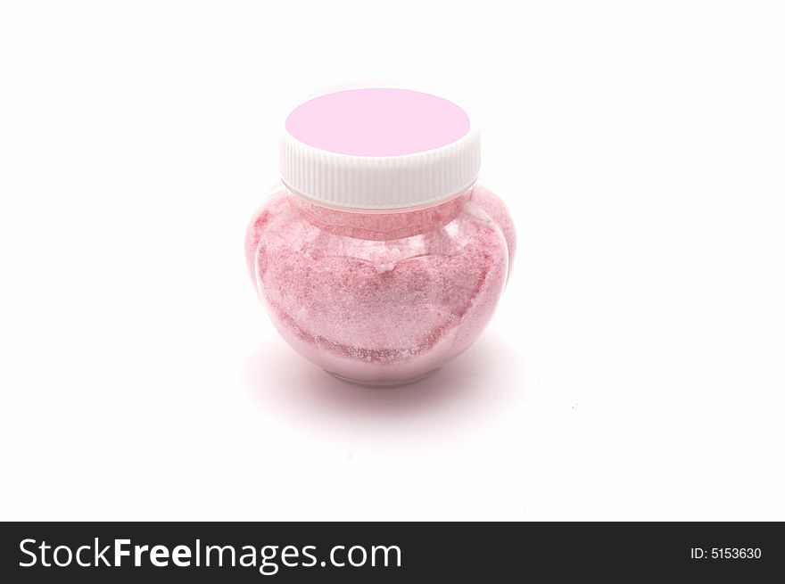 Plastic jar with salt for a bath on a white background