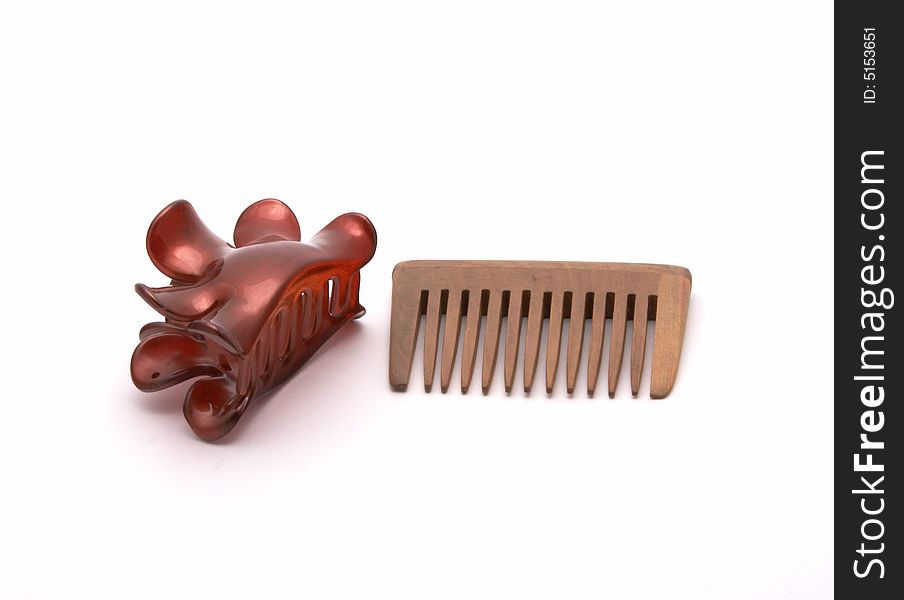 Hairbrush and hairpins on a white background