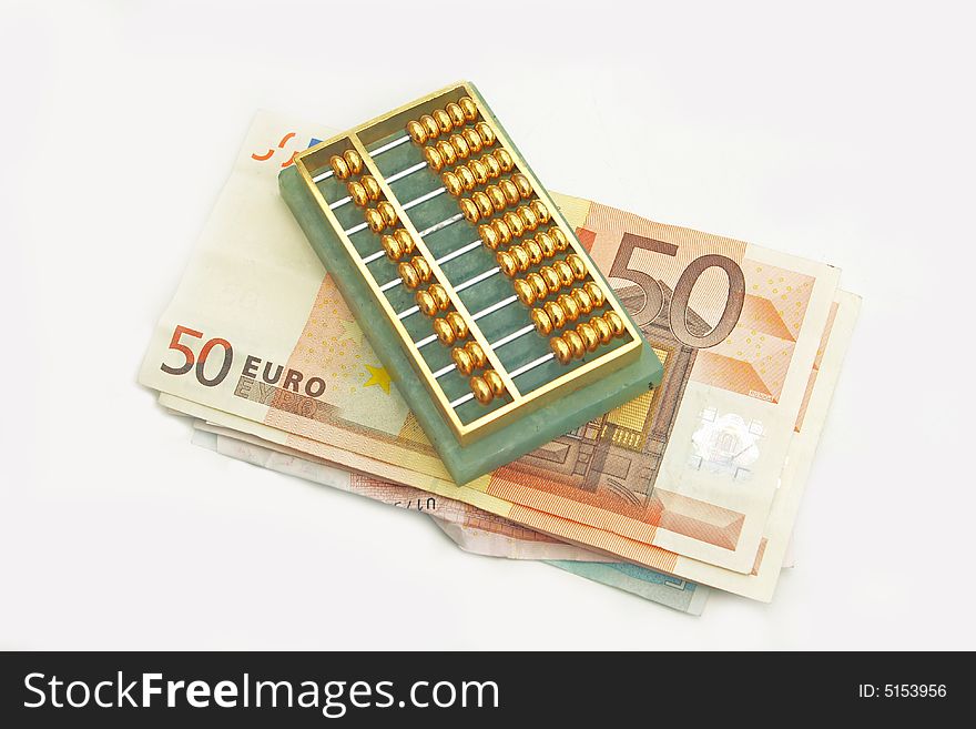 An old abacus sitting on a pile of euro notes,. An old abacus sitting on a pile of euro notes,