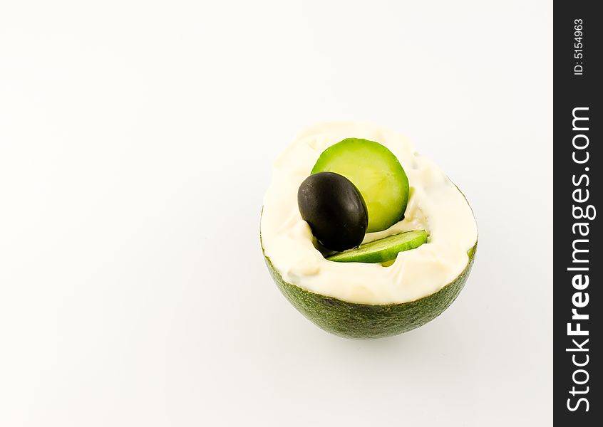 Mayonnaise over avokado with black olive over white background. Mayonnaise over avokado with black olive over white background