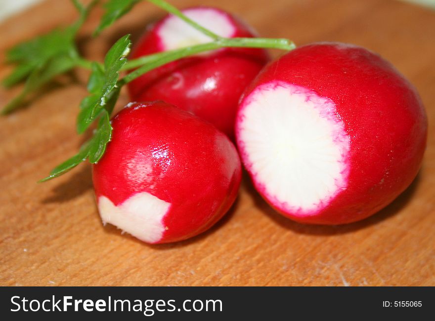 Red garden radish on a board