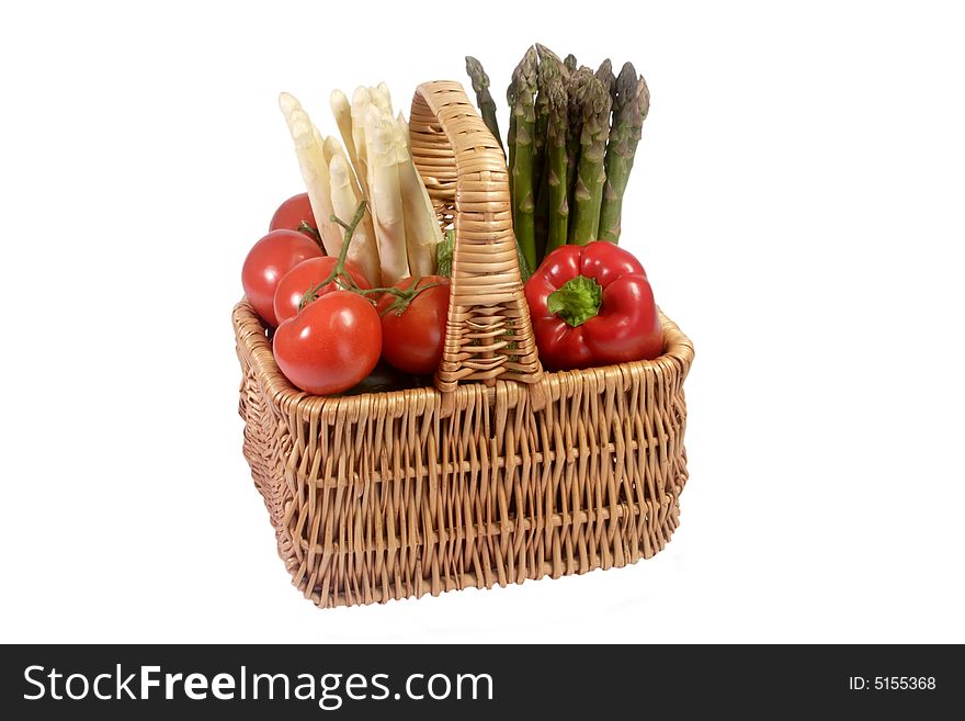 Differend sorts of vegetables in a basket - isolated on white background. Differend sorts of vegetables in a basket - isolated on white background