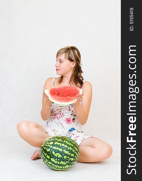 Sitting girl with water melon in hands. Sitting girl with water melon in hands