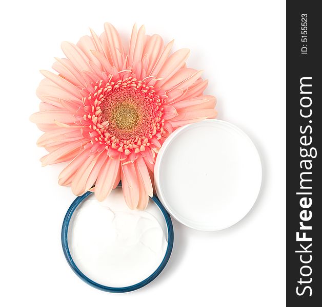 Moisturizing cream with pink gerbera close up