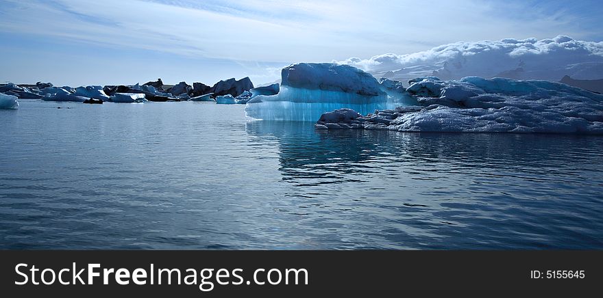 Panoramic view of a beautiful blue iceberg