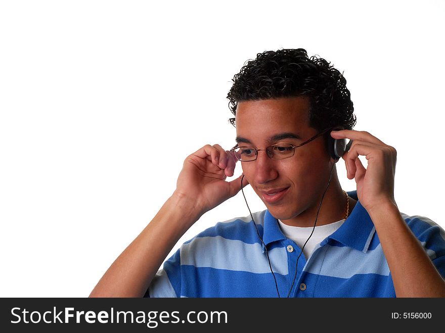 Young teen listening to music from his headphones. Young teen listening to music from his headphones