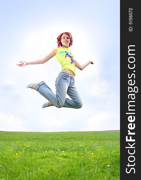 Young redhead girl jumping outdoors. Young redhead girl jumping outdoors