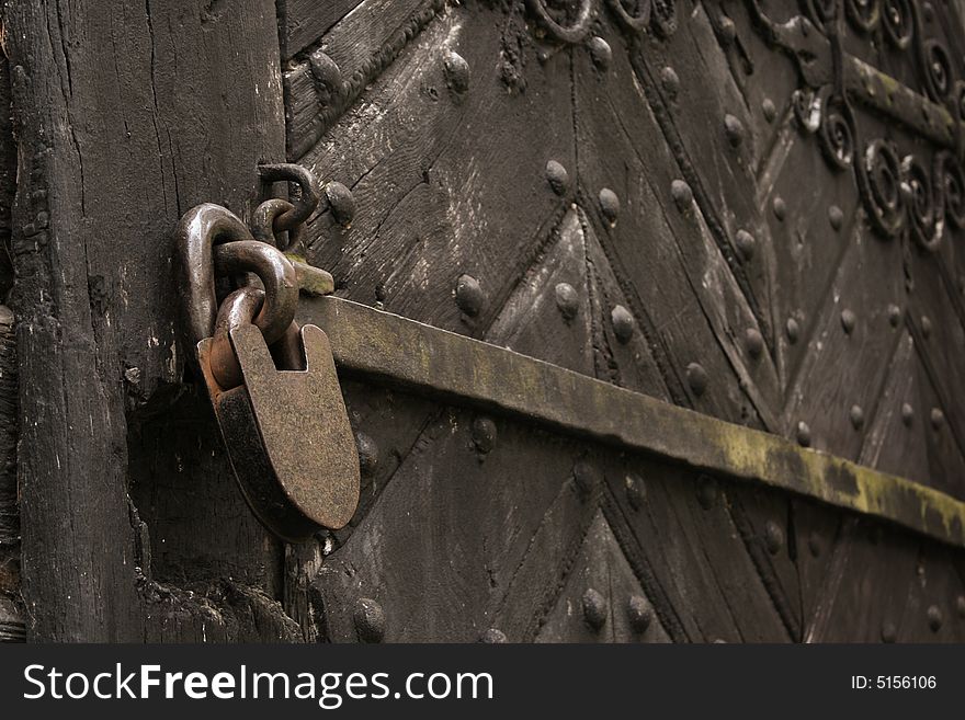 Old metal lock on the wooden door