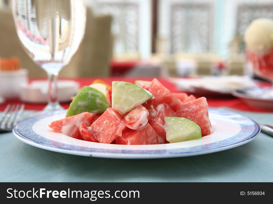 Appetizing salad on a plate with cup of drinking. Close up