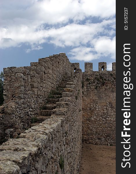 Castle wall perspective, isolated in blue sky background