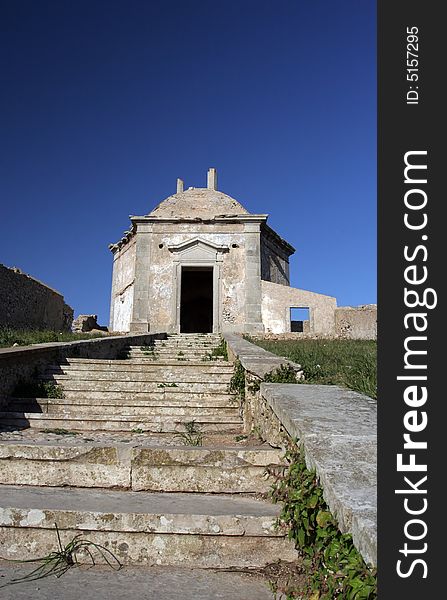 Path to a old church, isolated in blue sky