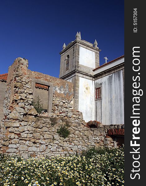 Old church over ruined castle, isolated in blue sky