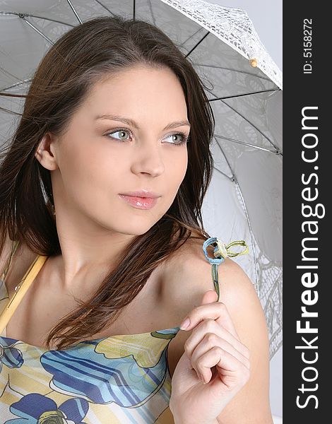 Young brunette girl with umbrella in white.