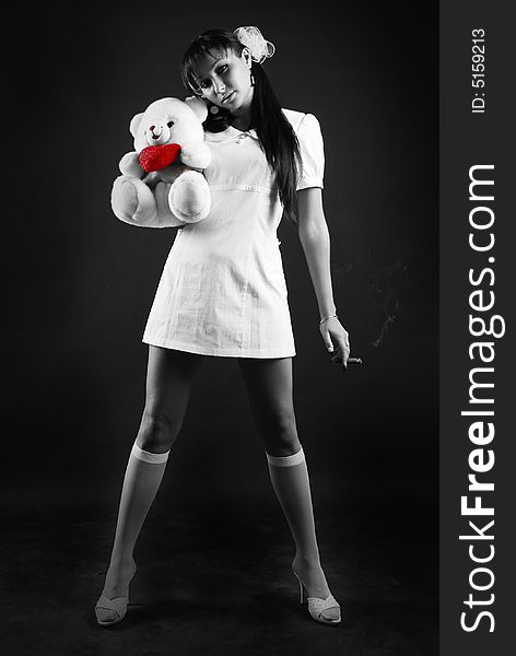 Beauty portrait of woman at black background with bear and cigare. Beauty portrait of woman at black background with bear and cigare