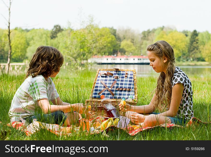 Two children enjoying a picnic in the summer. Two children enjoying a picnic in the summer