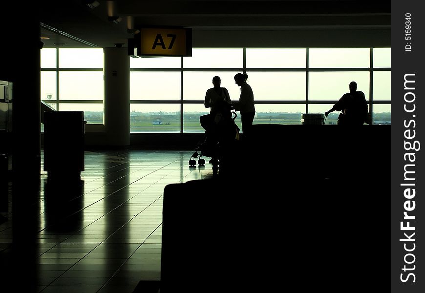 Silhouette of travelers in departure area of airport. Silhouette of travelers in departure area of airport