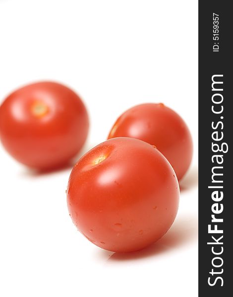 Fresh red juicy tomatoes with water droplets on white background