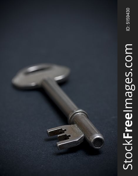 Door key on dark background