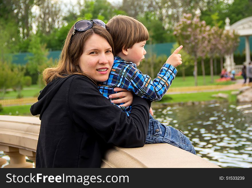 Mother and her son having wonderful time in the park in a lovely summer day. Mother and her son having wonderful time in the park in a lovely summer day