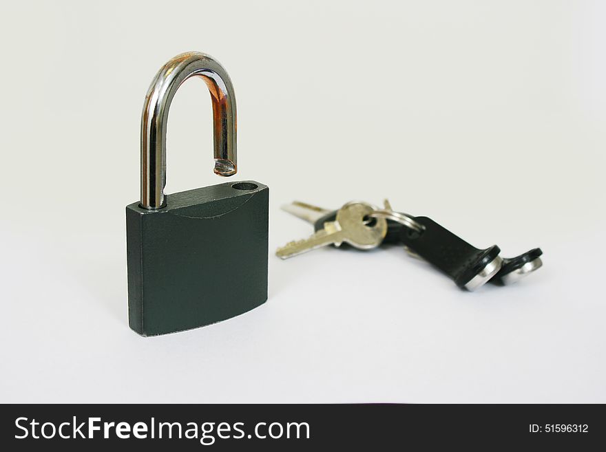 Standing lock with a bunch of keys on a white background