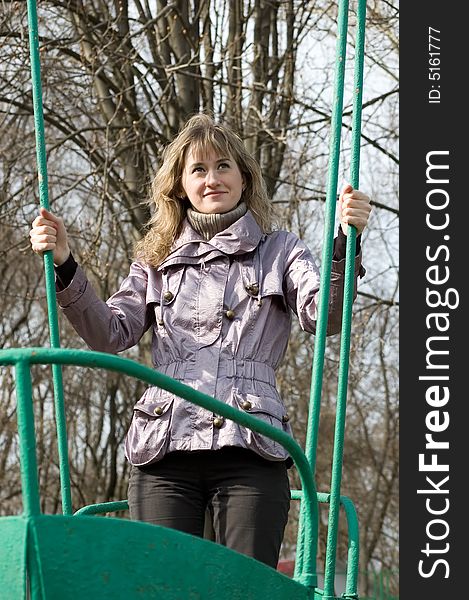 Girl in park on old swing