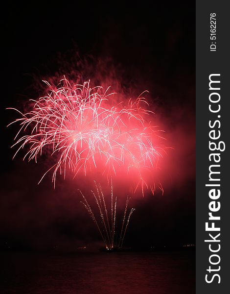 Bright red fancy fireworks against the dark sky