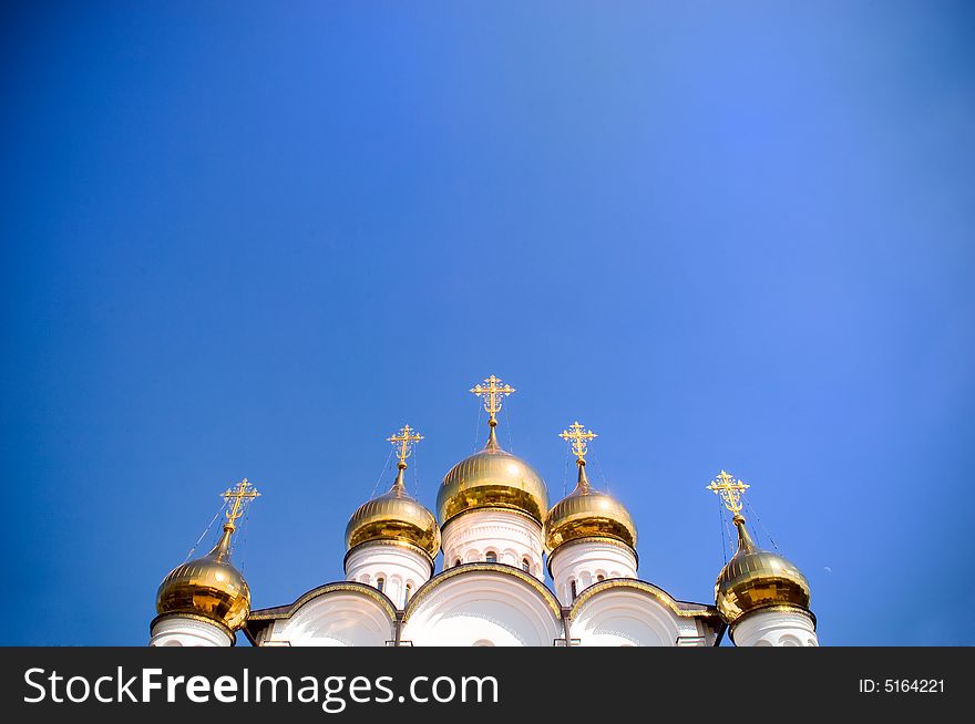 Golden church domes with copy-space