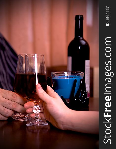 Close-up of a man and women hands with vine and candel