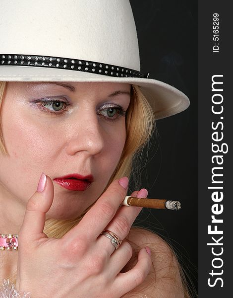 Lady with white hat smoking a cigarette