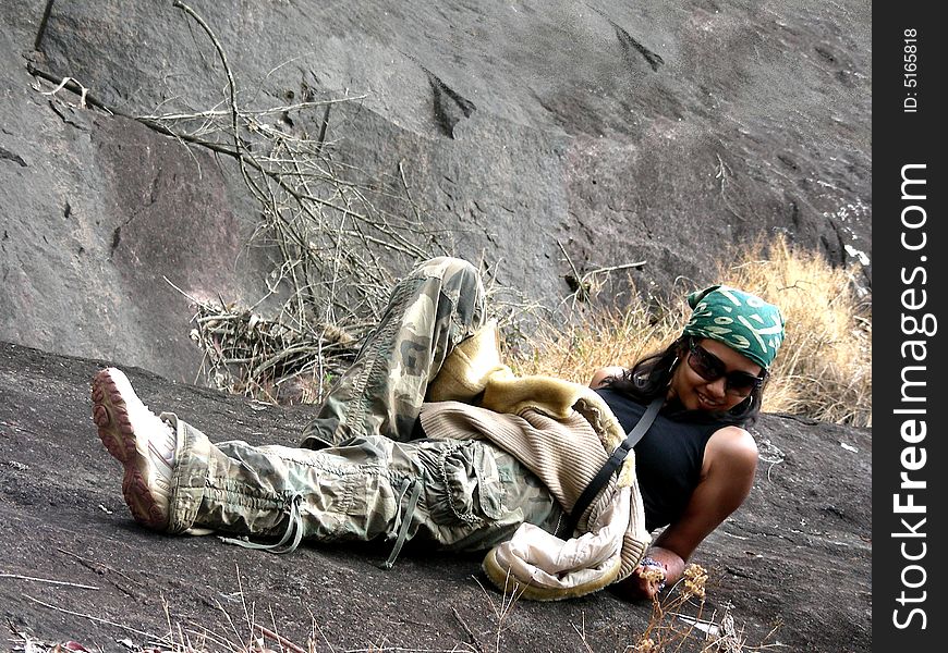 Stylish Indian model posing on the rocks, during an outdoor shoot. Stylish Indian model posing on the rocks, during an outdoor shoot