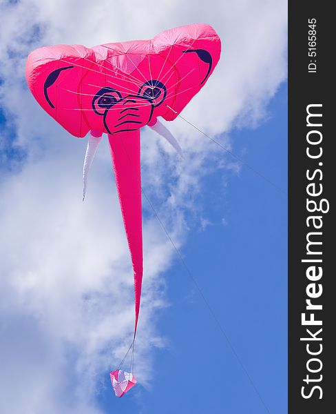 Elephant kite captured on cloudy but sunny day.