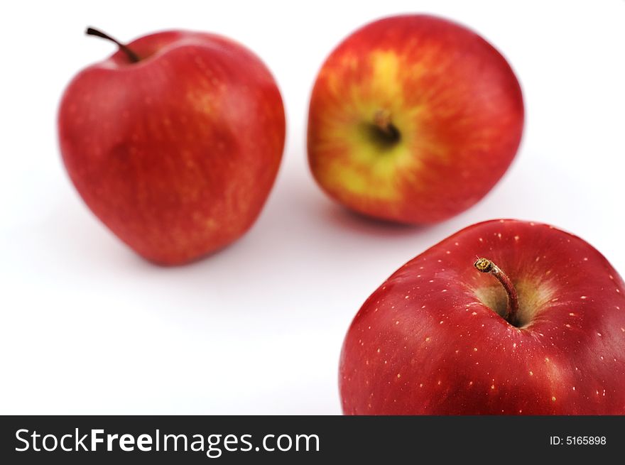 Three apples on white background with shallow depth of field