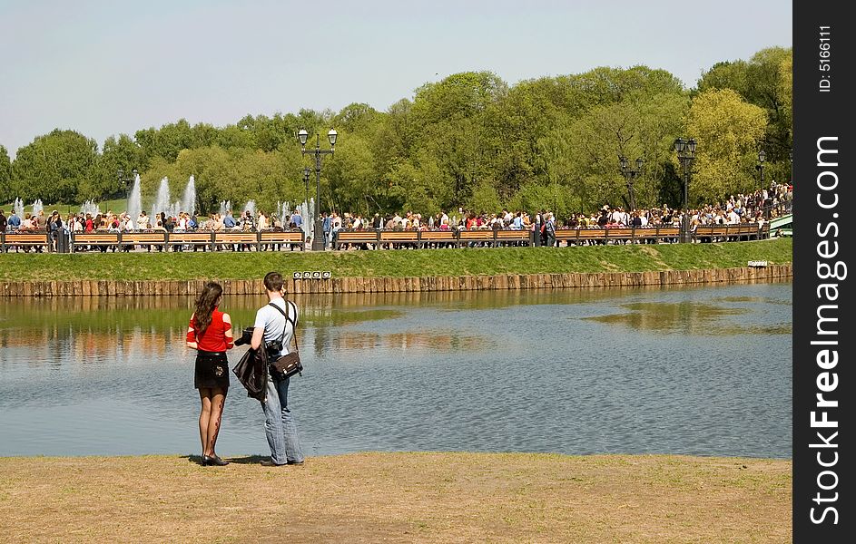 Married couple on a beach of park pond