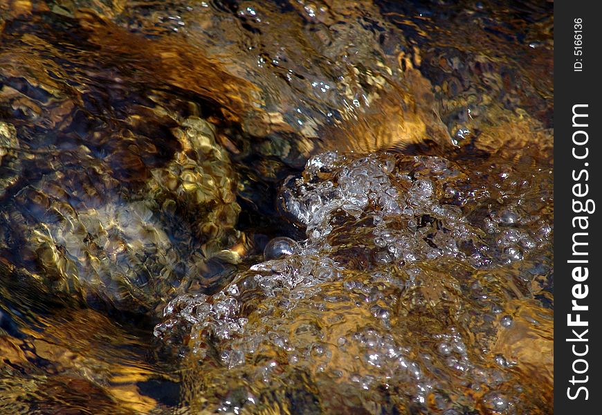 Sparks of water on stones, a rough stream of water. Sparks of water on stones, a rough stream of water